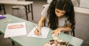 A young woman using TestAS preparation books to prepare for the TestAS